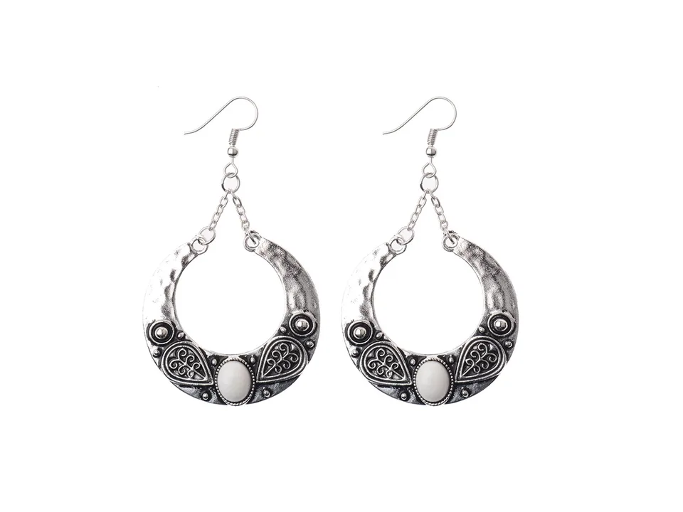 A pair of bohemian crescent-shaped earrings with white resin inlay.