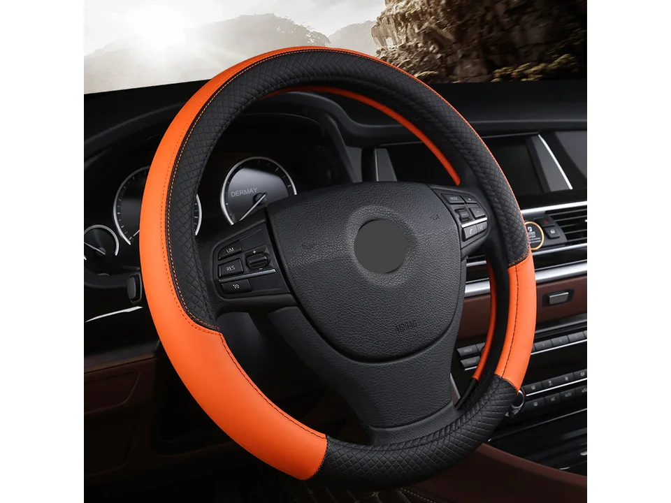 Orange and black leather steering wheel cover installed on a car steering wheel.