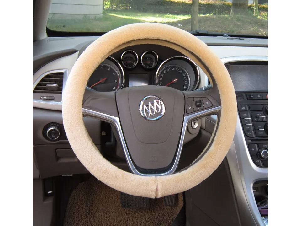 Beige plush steering wheel cover installed on a car steering wheel.