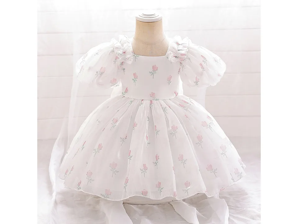 Front view of a white dress with pink floral print and puff sleeves on a mannequin.