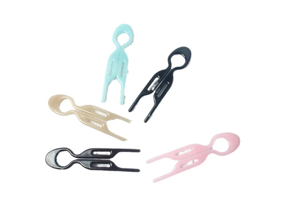 Five different colored U-shaped hair forks arranged on a white background.