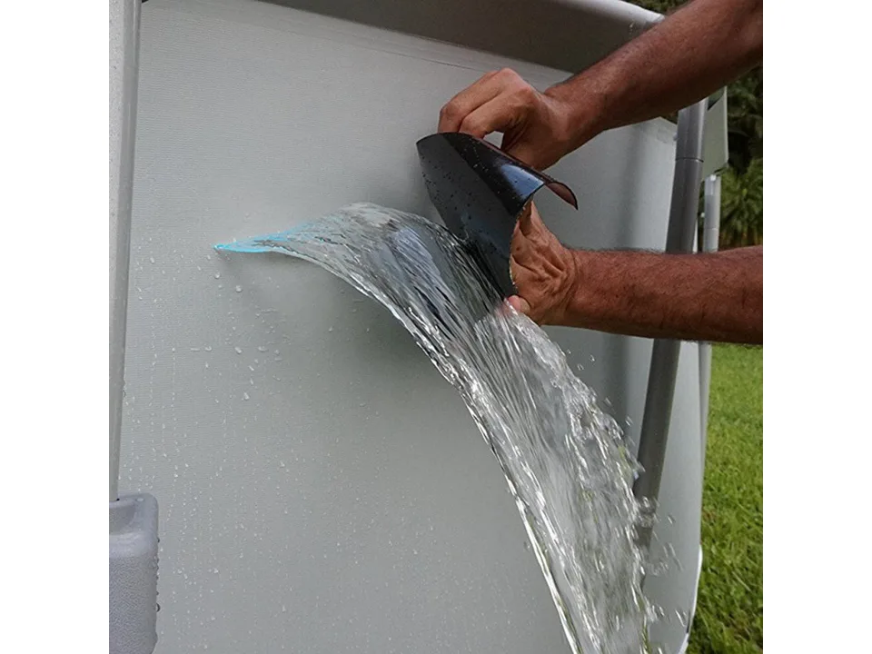 Hands applying adhesive tape to a leaking pool wall.