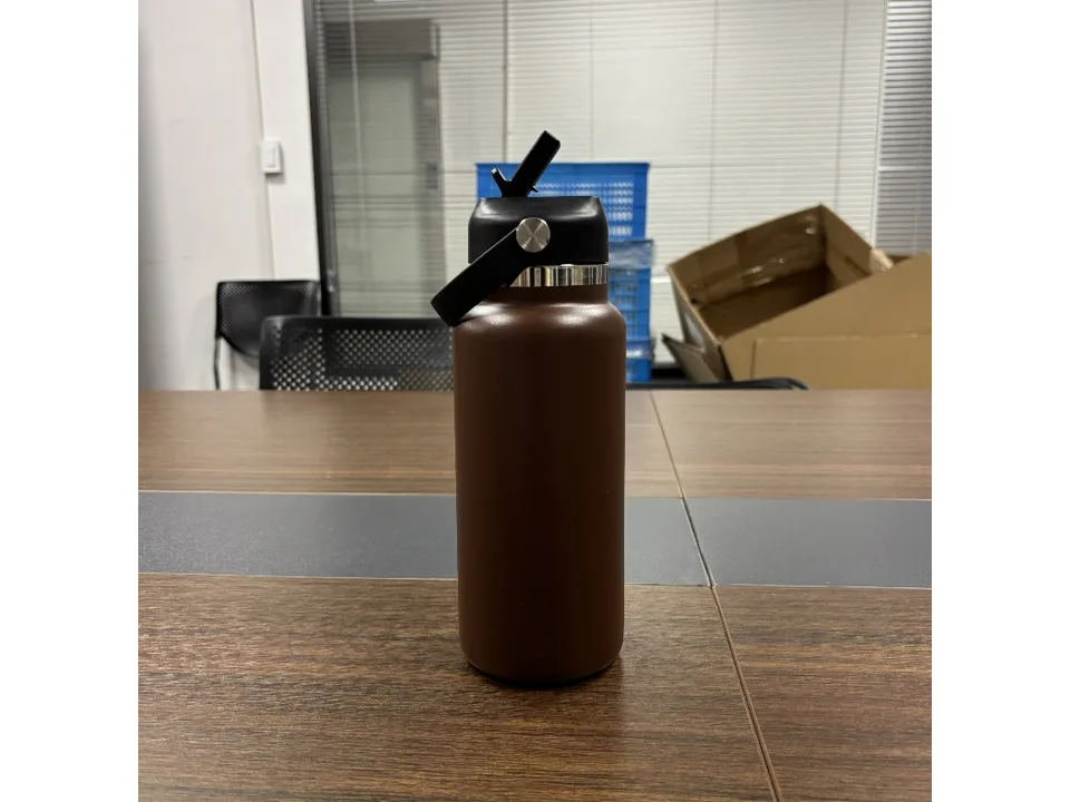 Brown water bottle with the straw lid flipped up.
