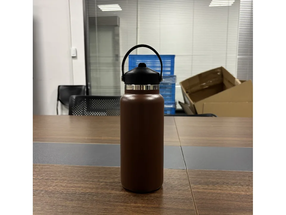 Brown stainless steel insulated water bottle with a black lid and carry handle.