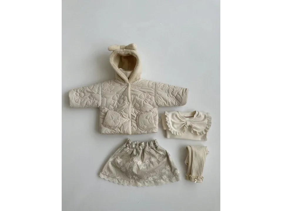 A baby girl's outfit set including a quilted jacket, a blouse with a lace bow collar, a skirt, and leggings.
