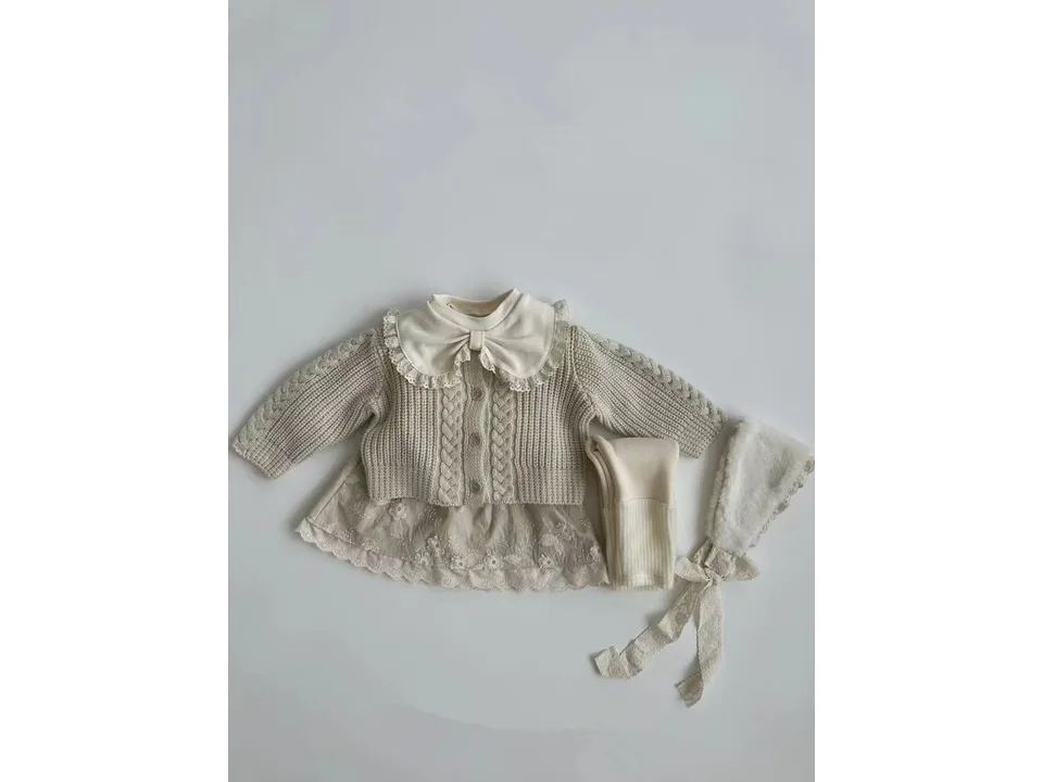 A baby girl's outfit set with a cable-knit cardigan, a blouse with a lace bow collar, leggings, and a bonnet.