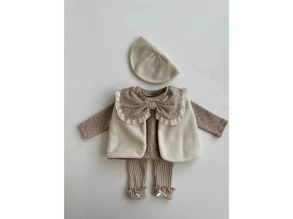 A baby girl's outfit set featuring a floral blouse with a lace bow collar, a vest, leggings, and a beret.