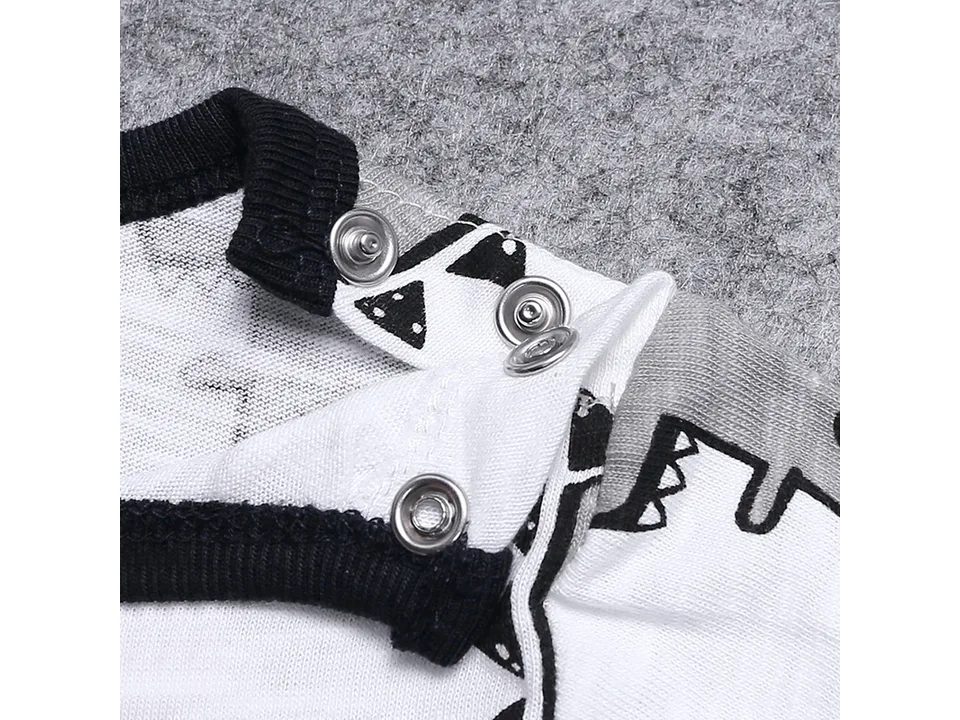 Close-up of the metal snap buttons on the shoulder of the baby romper.