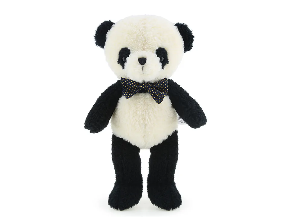 A plush panda toy with a polka-dot bow tie standing against a white background.