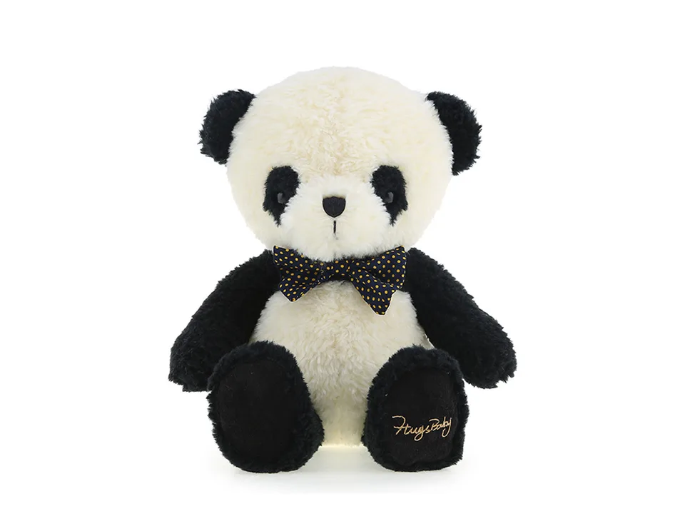 A plush panda toy with a polka-dot bow tie sitting down.