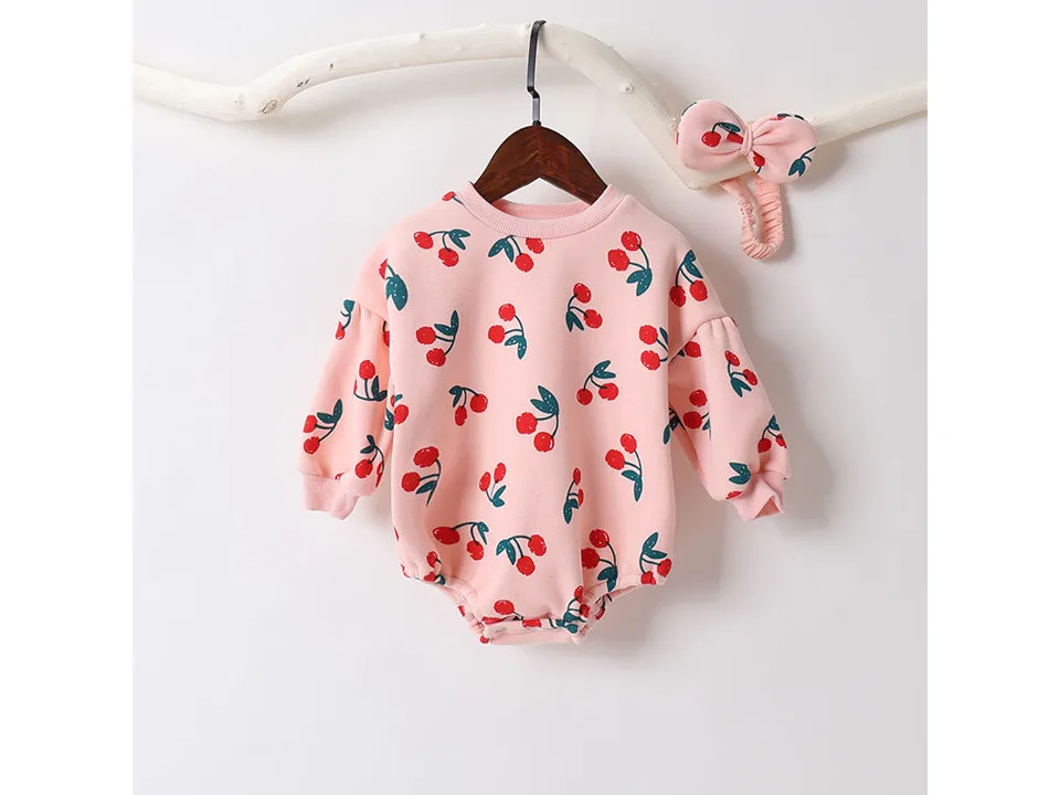 Cherry print baby jumpsuit on a hanger with matching headband