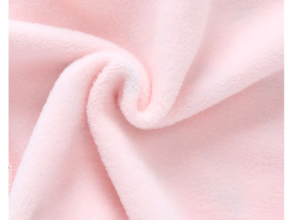 Close-up of the soft pink fabric texture of the baby jumpsuit