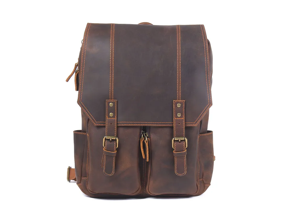 Front view of a brown leather backpack with a flap and buckle details.