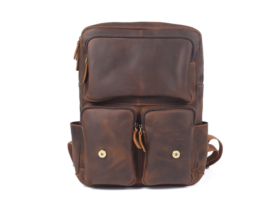 Front view of a brown leather backpack with multiple pockets.