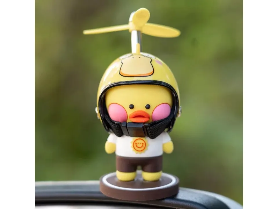Close-up of a cartoon duck ornament wearing a corgi-themed helmet with a propeller.