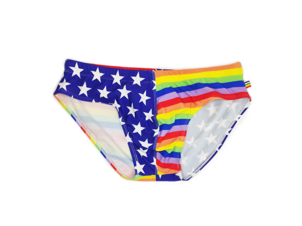 Men's swim briefs with a stars and stripes pattern on one side and rainbow stripes on the other.