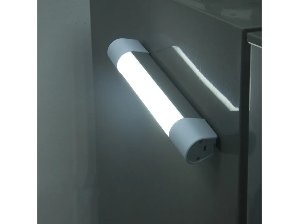 The LED tube light attached magnetically to a metal surface.