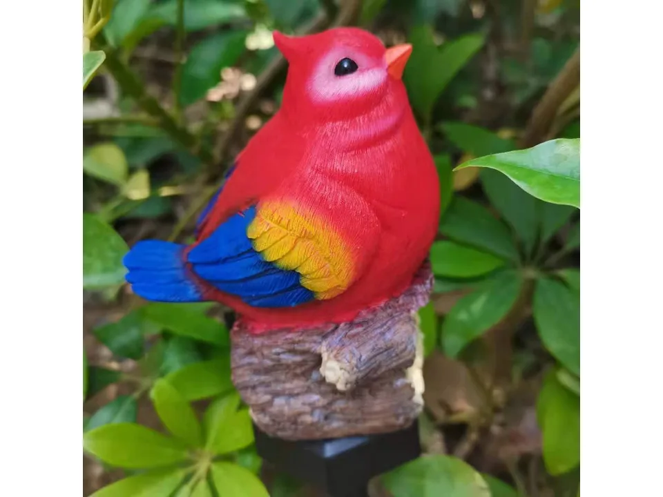 Close-up of a red bird garden light ornament.