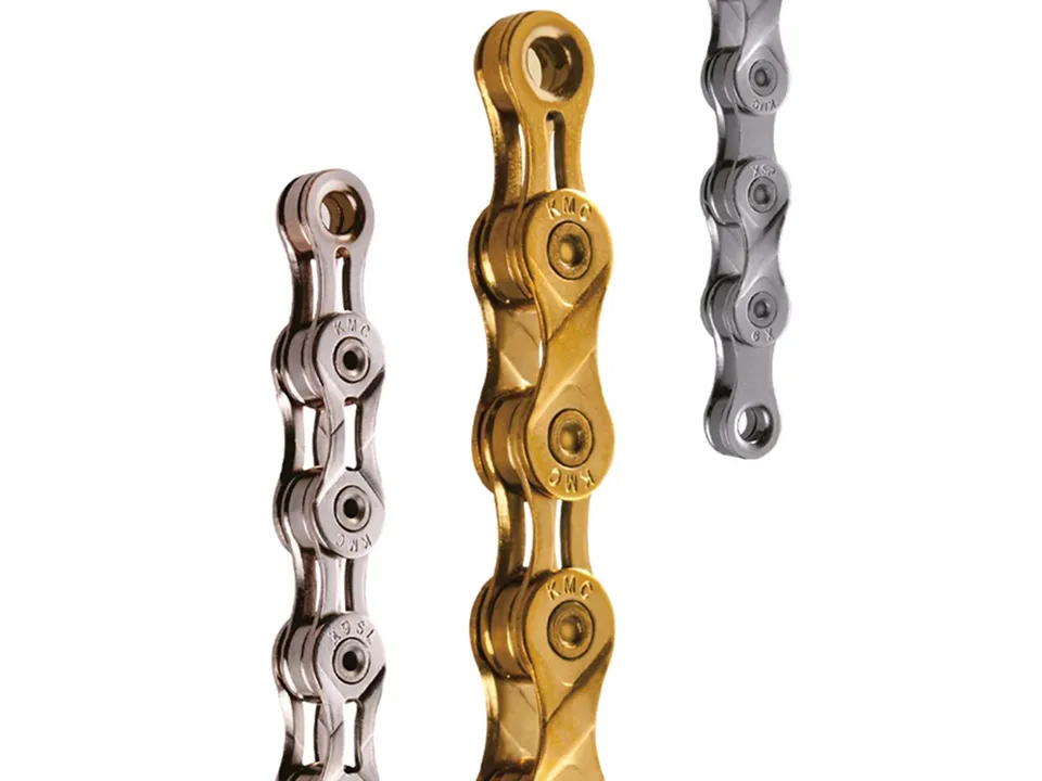 Close-up view of three different colored bicycle chain segments showing the link construction.