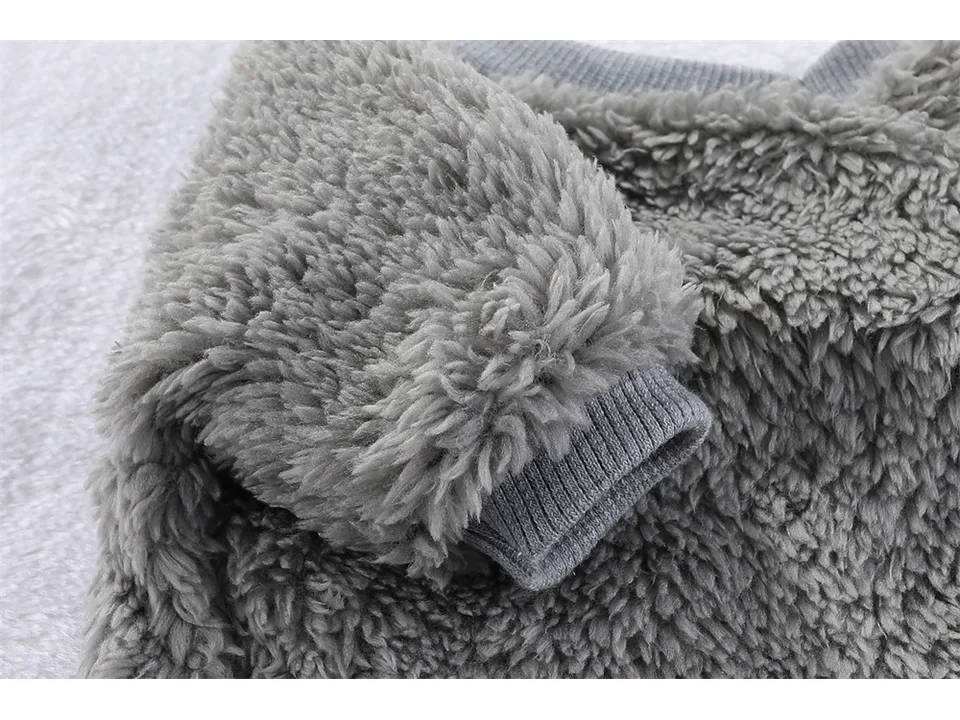 Close-up of the sleeve and ribbed cuff on the grey fleece sweater.