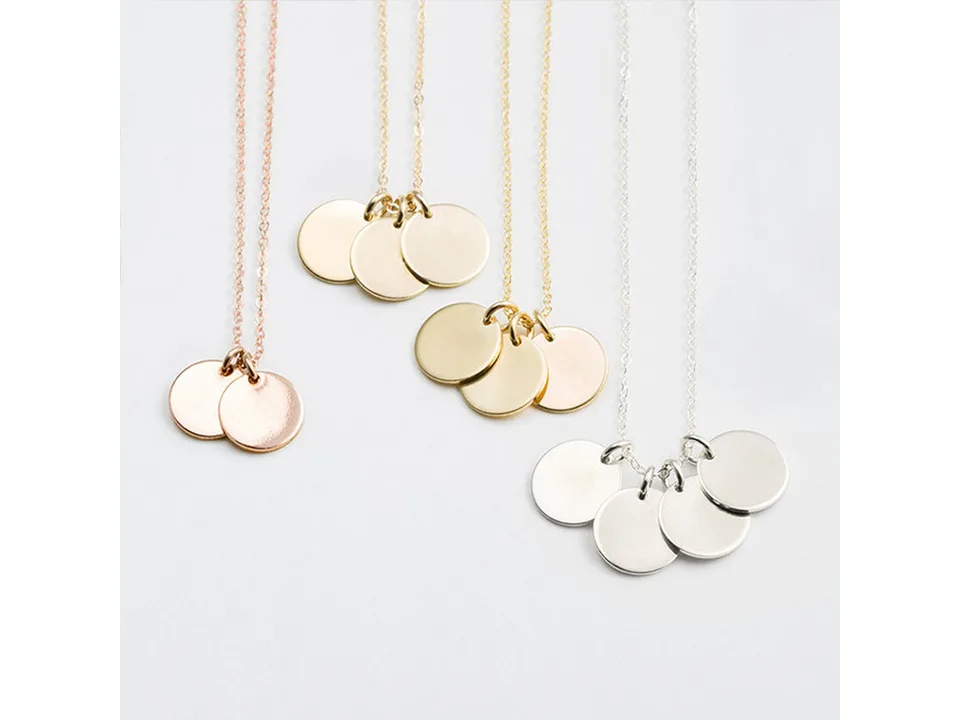 Three gold, rose gold, and silver necklaces with varying numbers of round pendants.