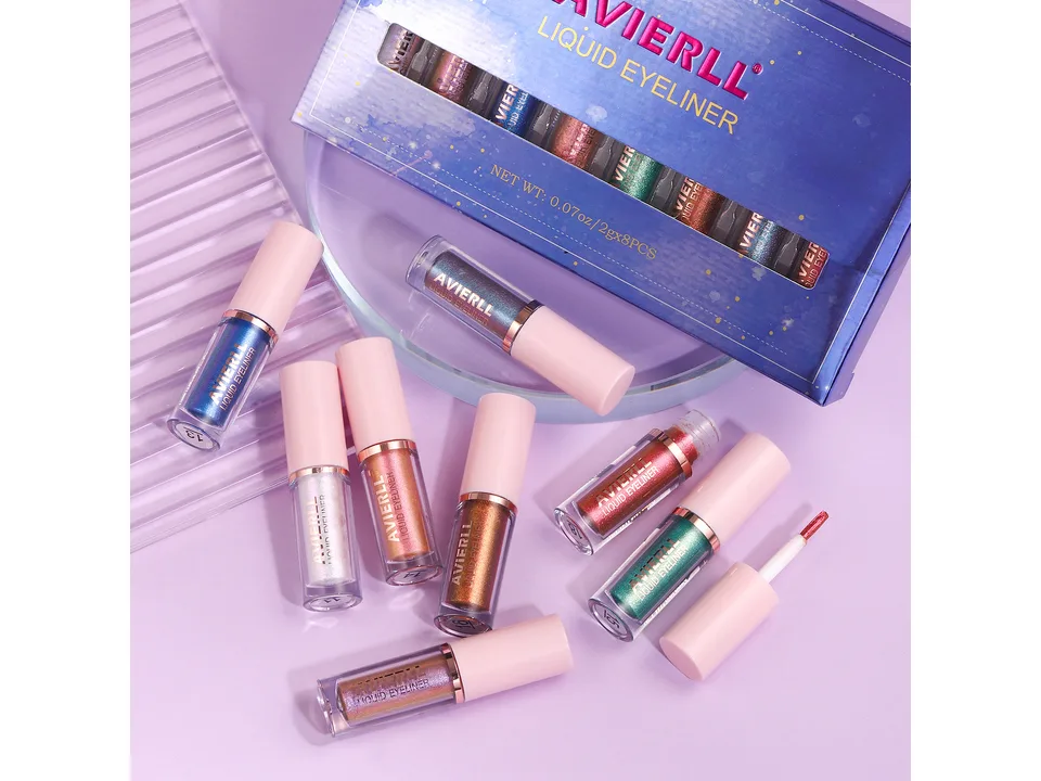 A set of eight colorful glitter liquid eyeliners arranged with their box.
