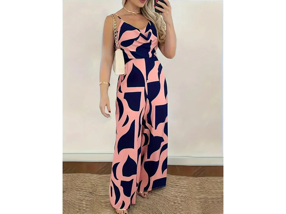 A woman wearing a pink and navy blue patterned sleeveless wide-leg jumpsuit.