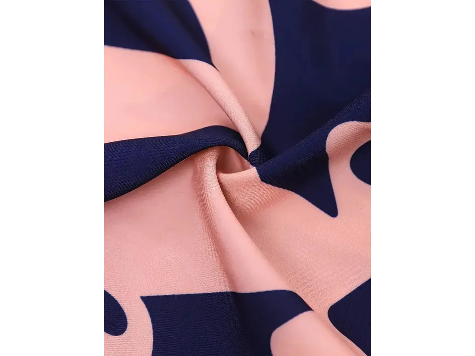 Close-up of the pink and navy blue fabric pattern of the jumpsuit.