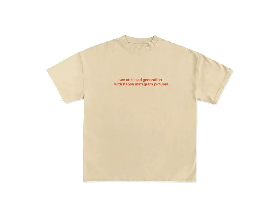 Beige t-shirt with the text 'we are a sad generation with happy instagram pictures' in red.