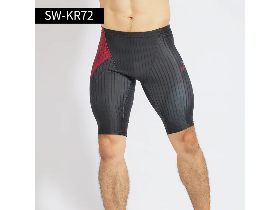 Model wearing black and red striped athletic swimming trunks.