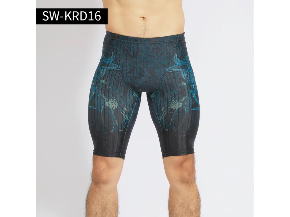 Model wearing dark patterned athletic swimming trunks.