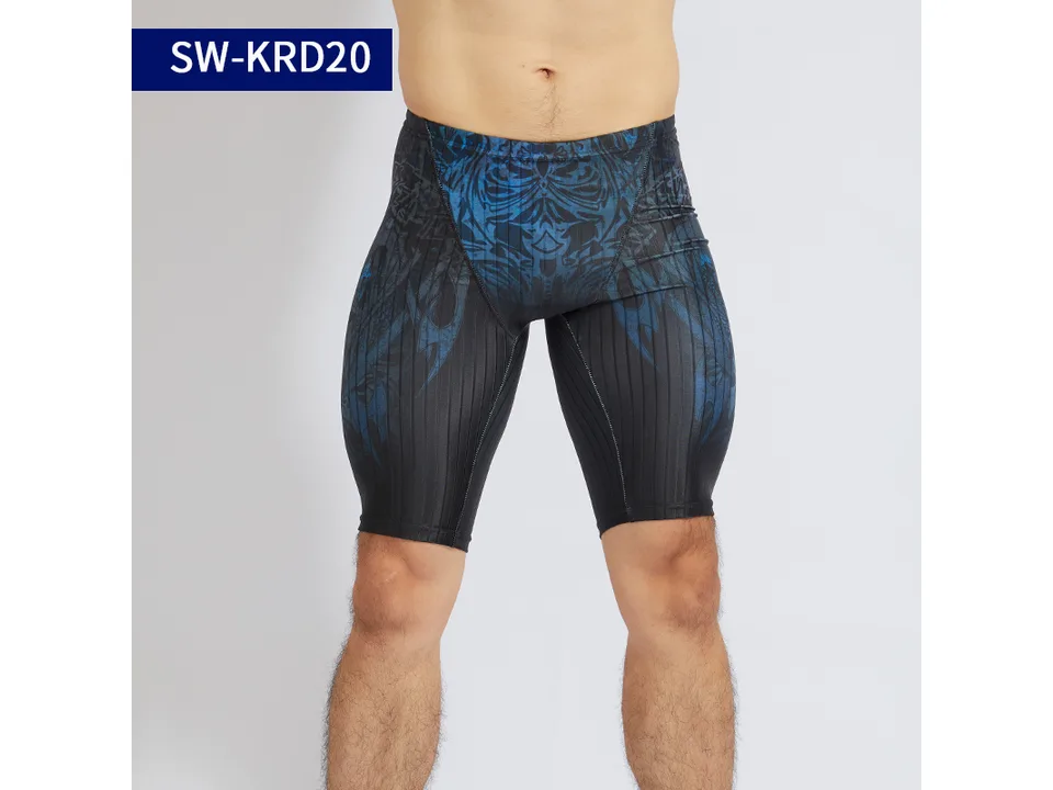 Model wearing blue patterned athletic swimming trunks.