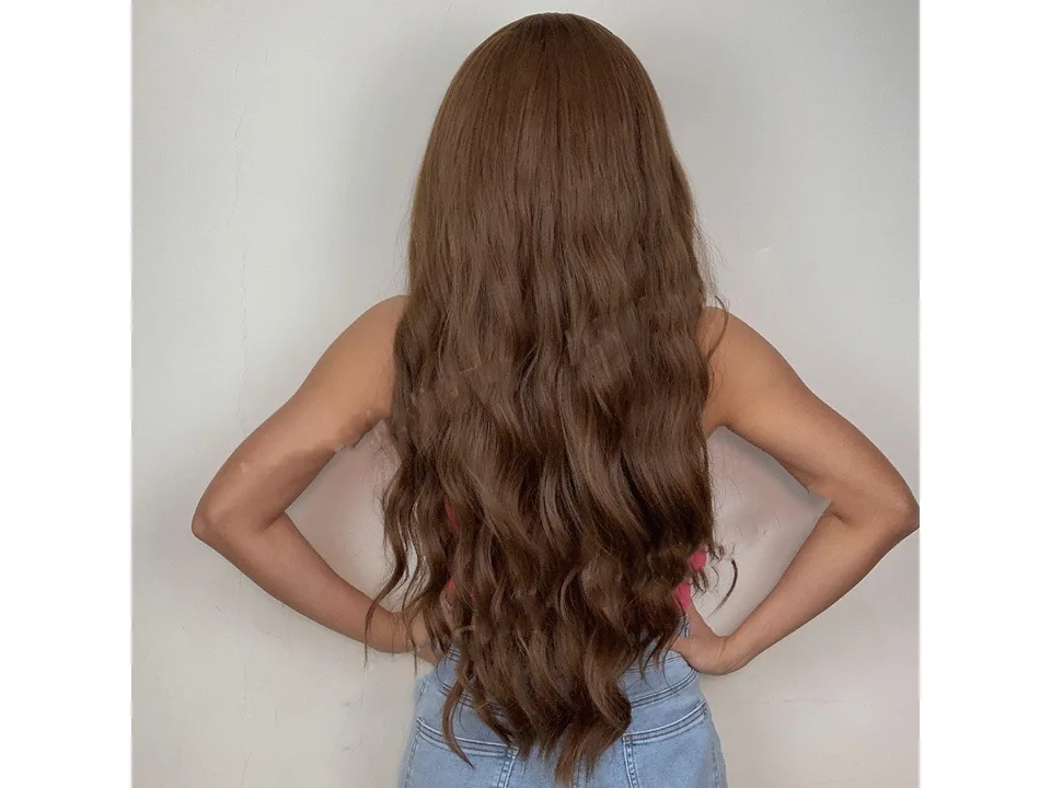 Back view of a woman with long, wavy medium brown hair.