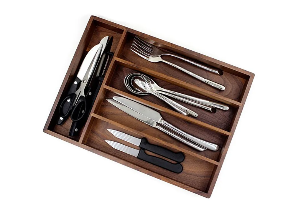 Wooden cutlery organizer tray filled with various kitchen utensils like forks, spoons, and knives.