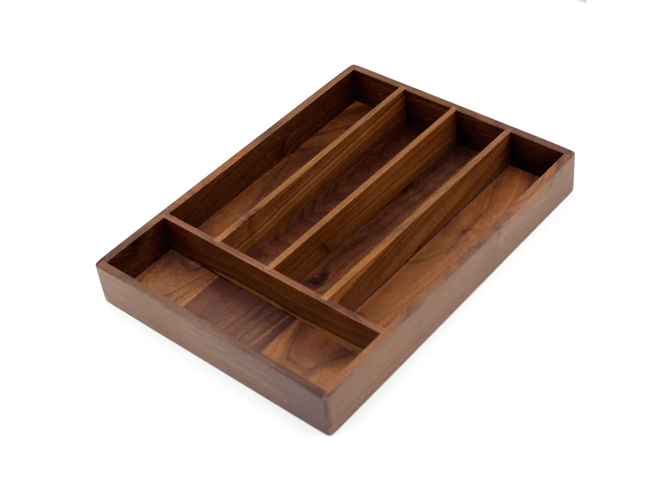 Empty wooden cutlery organizer tray on a white background.