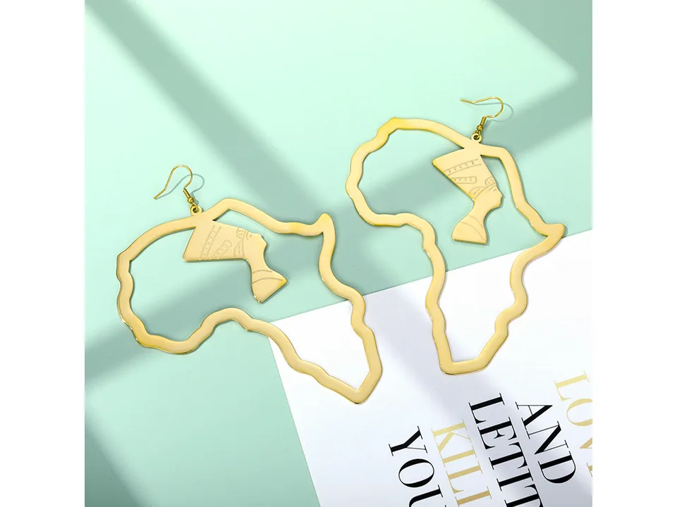 Gold-tone African map earrings with Egyptian queen silhouette on a light green background.