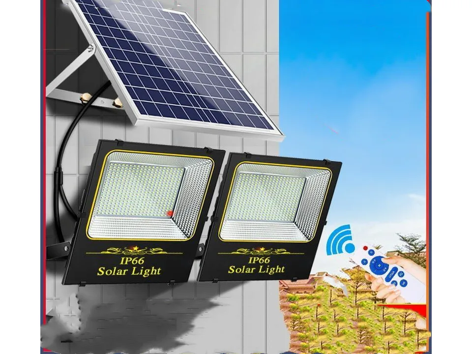 Solar floodlights with a hand holding the remote control.