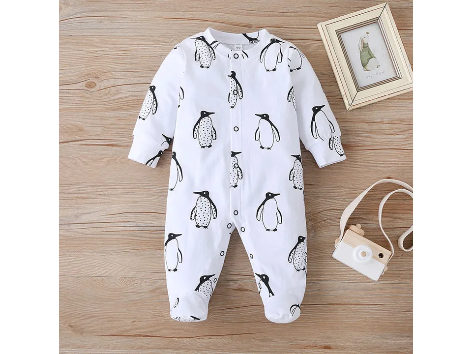 Full view of the white long-sleeve footed baby jumpsuit with a penguin print.