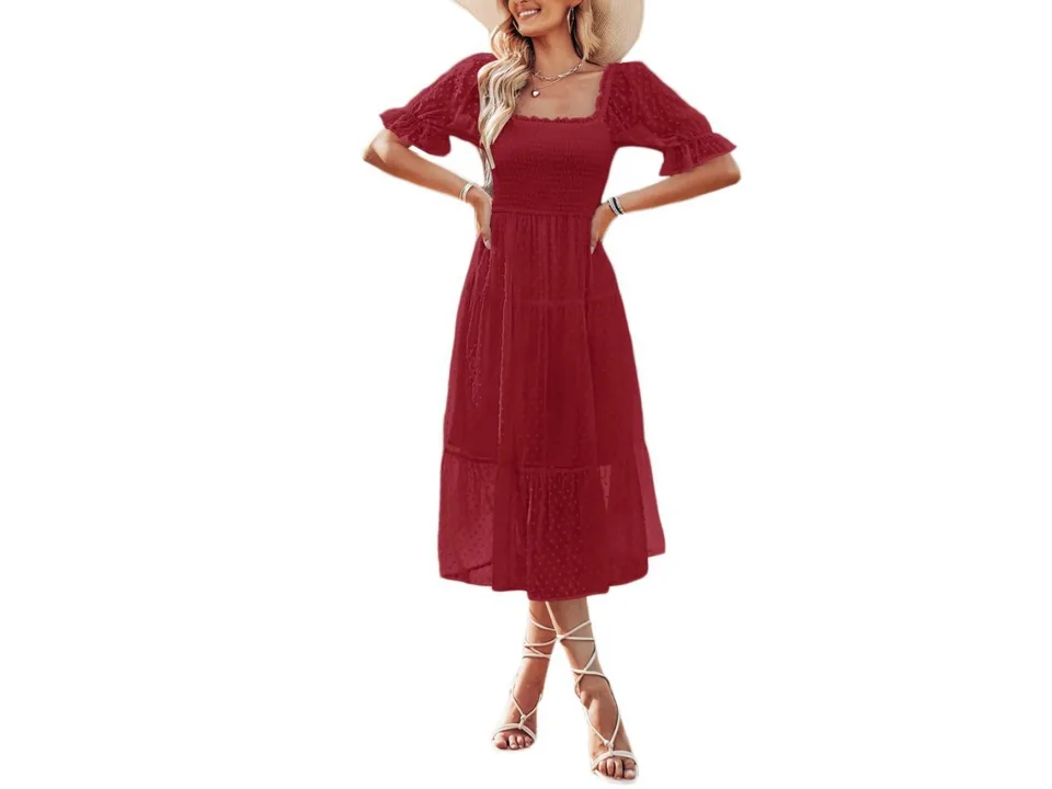 A woman wearing a red square neck midi dress with short sleeves and a tiered skirt.