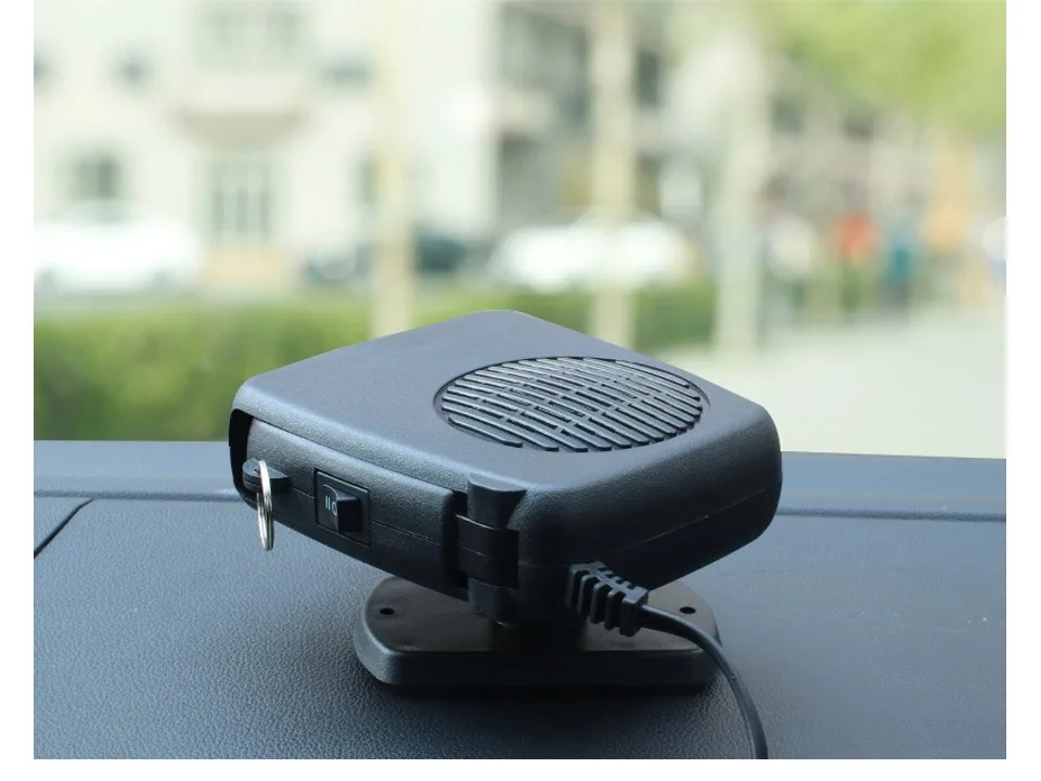 Portable car heater and defroster unit sitting on a dashboard.