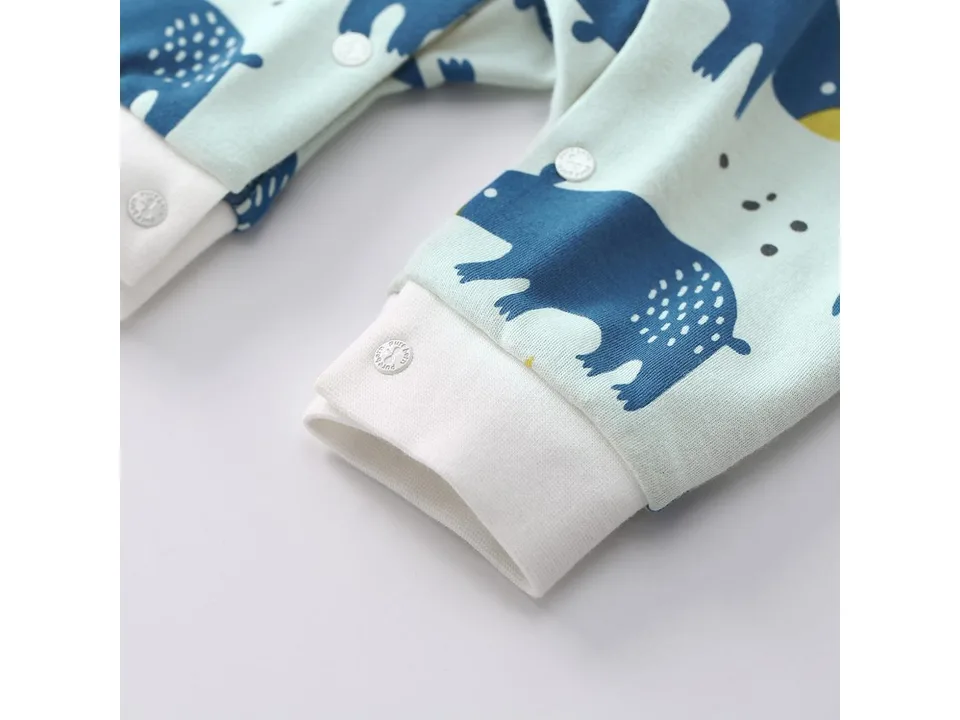 Close-up of the sleeve cuff and snap button on the baby jumpsuit.