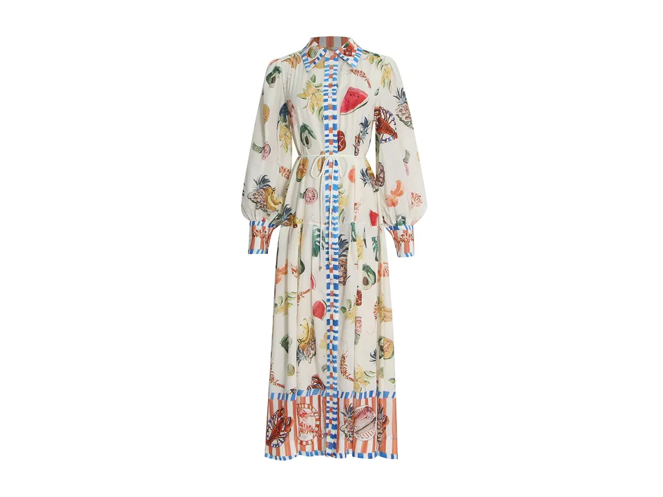 Full length view of a cream-colored maxi shirt dress with a colorful fruit and seafood print.