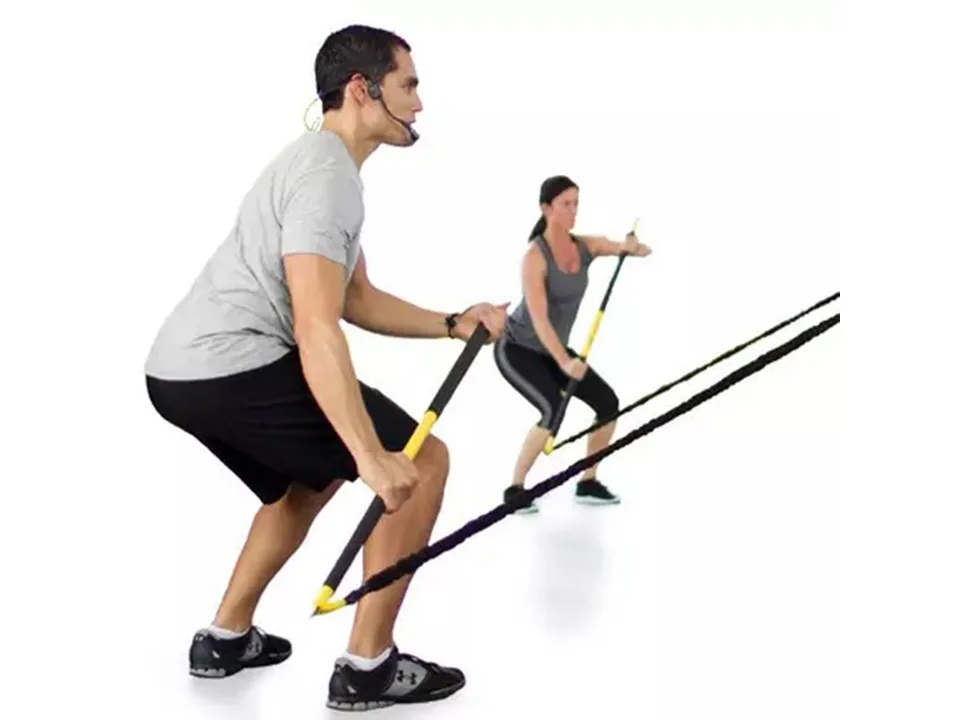 A man and a woman demonstrating exercises with the resistance bar.