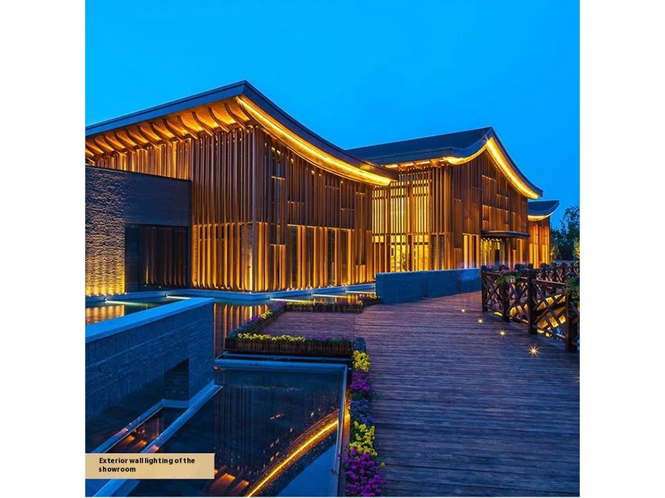 Outdoor LED spotlight illuminating the exterior wall of a modern building at night.