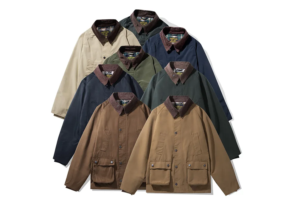 A collection of field jackets in various colors stacked together.
