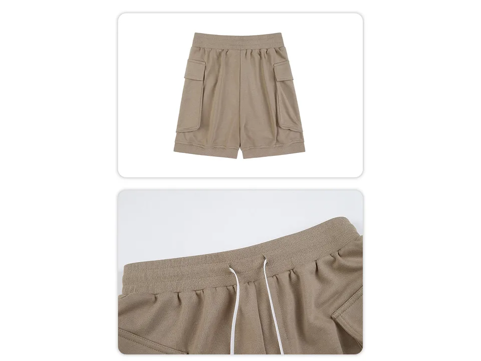 Close-up of the elastic waistband and drawstring on the beige cargo shorts.