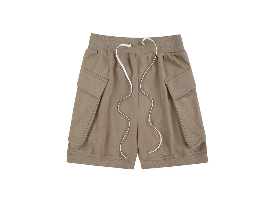 Beige cargo shorts with large side pockets and a drawstring waist.