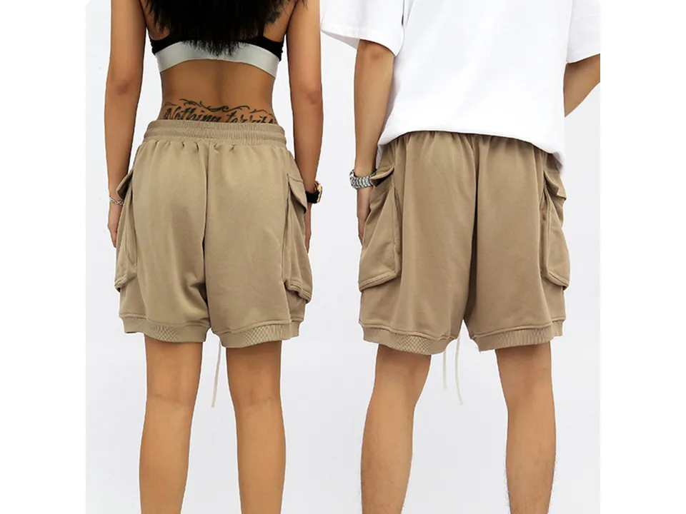 Back view of two people wearing the beige cargo shorts.