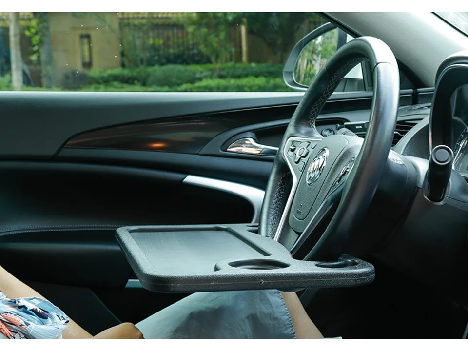 A car steering wheel tray attached to a steering wheel.