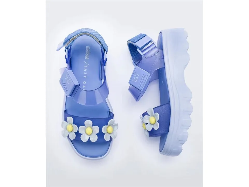 Blue platform sandals with white flower embellishments on the strap.